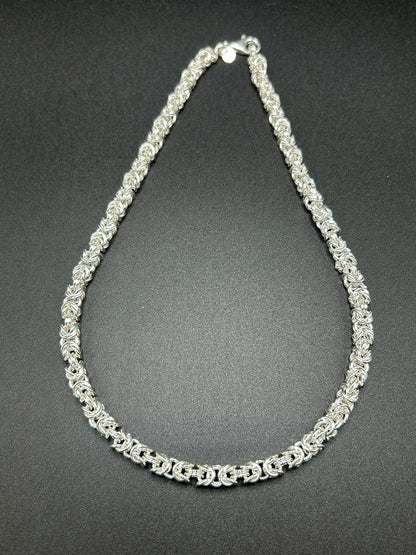 Una collana importante, costruita interamente attraverso l’intreccio della tradizionale maglia bizantina. I singoli elementi in argento sterling 925 si susseguono creando una trama ricca e tridimensionale, capace di catturare la luce e dare carattere al gioiello.

E' una collana dal design deciso ma senza tempo, pensata per essere indossata da sola come protagonista.